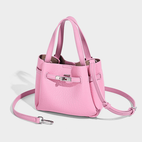 Small structured pebbled bucket tote with double top handles, silver turn-lock hardware, and detachable shoulder strap