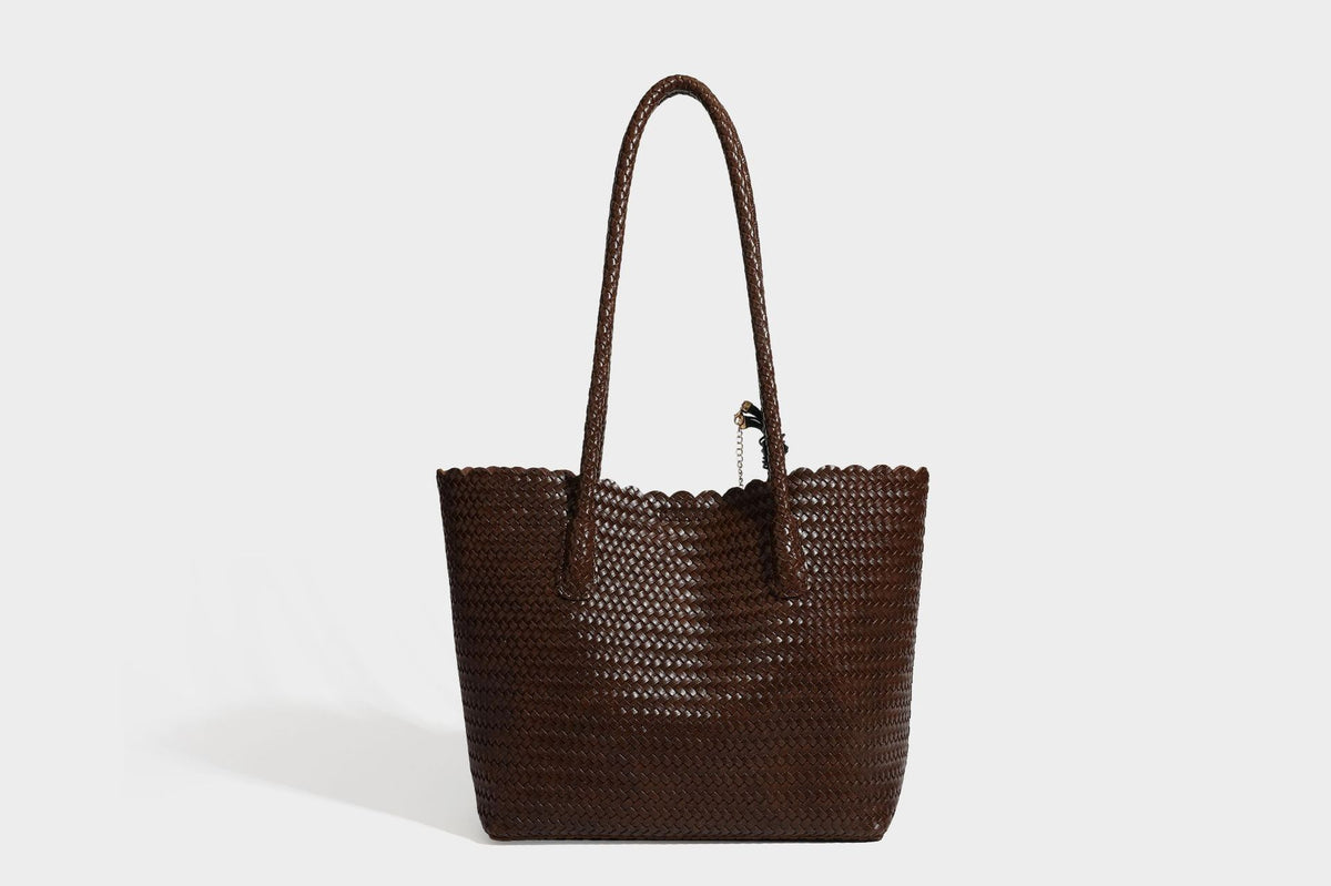 Large open-top woven leather-look tote bag in dark brown with scalloped edge, braided double shoulder straps, and decorative
