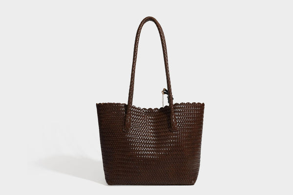 Large open-top woven leather-look tote bag in dark brown with scalloped edge, braided double shoulder straps, and decorative