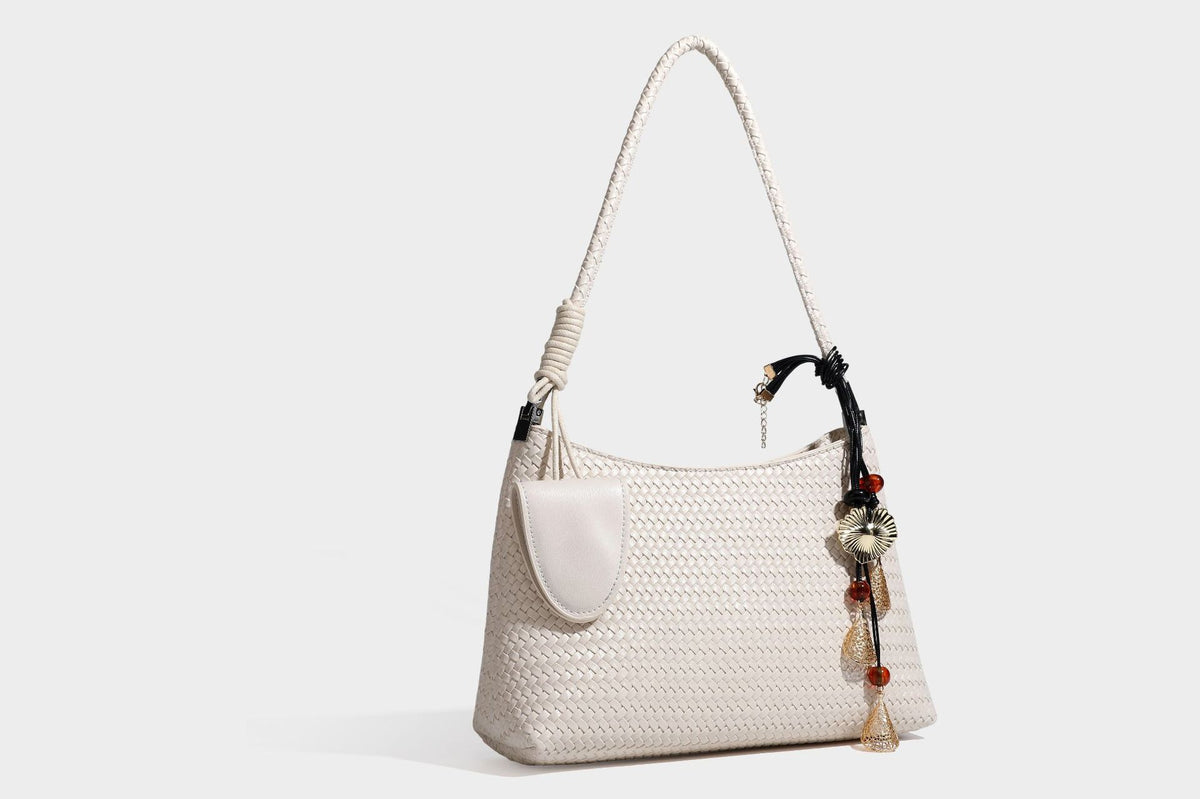 Woven-texture hobo shoulder bag in brown with braided top handle, adjustable crossbody strap, front flap pocket, and, detail