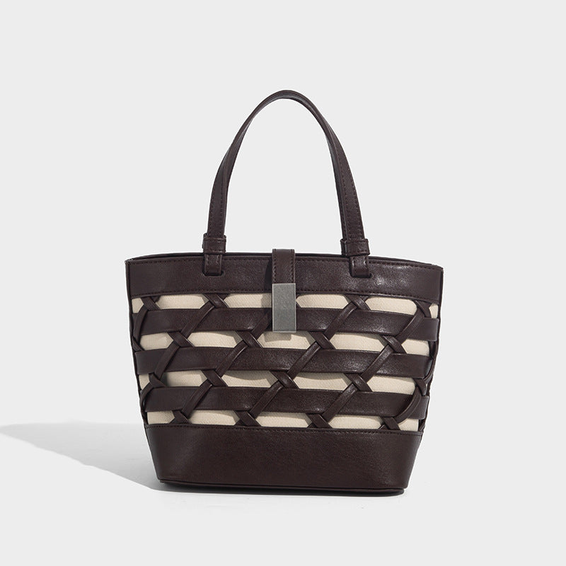 Structured woven lattice tote bag with cream lining, dual top handles, detachable crossbody strap, and silver-tone hardware