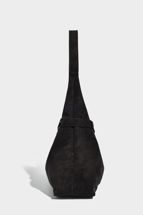 Slouchy oversized shoulder tote bag with matte textured finish, wrap-around buckle strap, and detachable front zip pouch