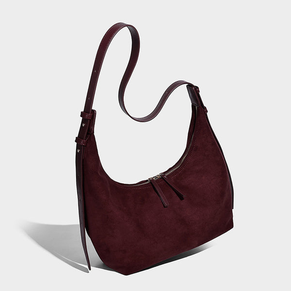 Slouchy crescent hobo shoulder bag in dark chocolate matte suede-look finish with adjustable strap and twin-pull top zip