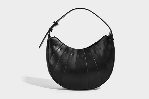 Crescent half-moon shoulder bag with vertical panel seaming, matte-satin leather-look finish, and adjustable gold-tone