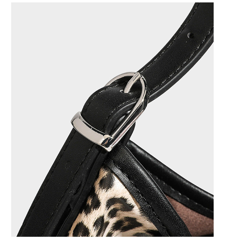 Slouchy leopard print shoulder hobo bag with black leather-look trim, tie-top closure, and single long strap, detail view 19