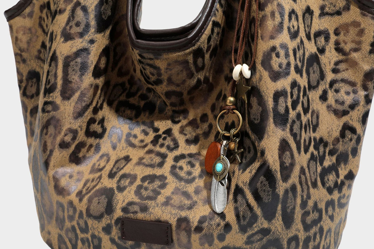 Large slouchy leopard-print shoulder tote bag with glossy tan-and-brown finish, dark brown leather-look trim, single