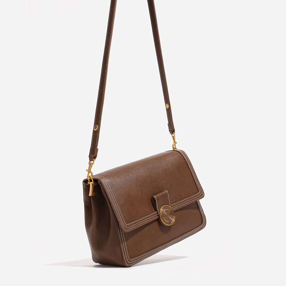 Structured flap shoulder bag with gold-tone circular turn-lock closure, white contrast stitching, and adjustable strap