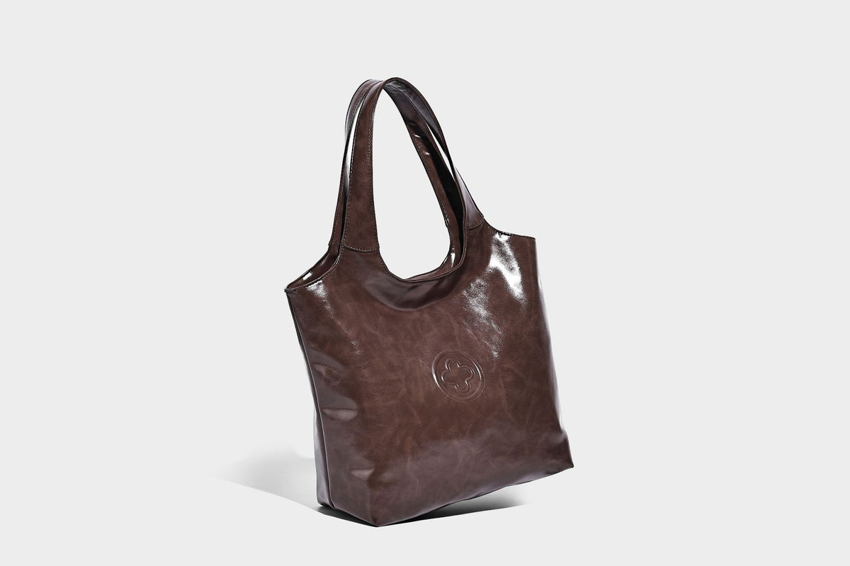 Glossy oil-wax leather-look open-top tote shoulder bag with embossed circular logo and long double straps, detail view 24