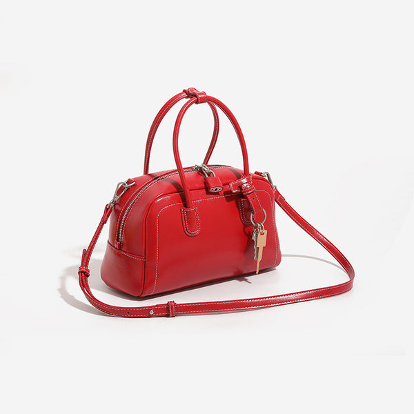 Compact retro Boston satchel bag with matte suede-look finish, twin rounded top handles, double zip closure with silver-tone