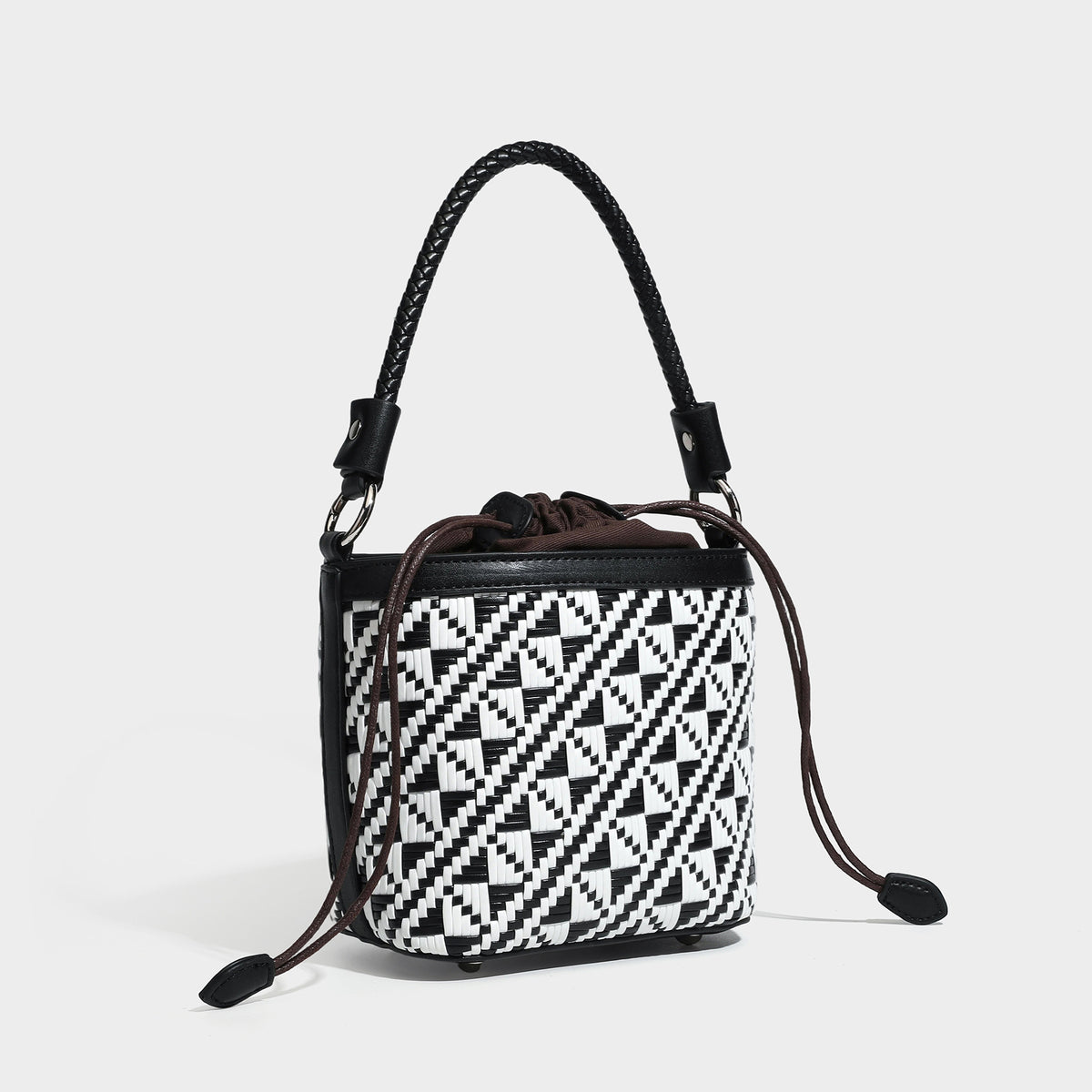 Small woven geometric bucket bag with braided leather-look handle and drawstring closure in brown and white two-tone pattern