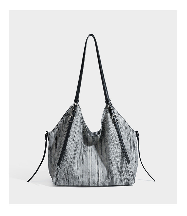 Large slouchy woven-texture shoulder tote bag with slim leather-look straps, side cinch ties, and silver-tone hardware