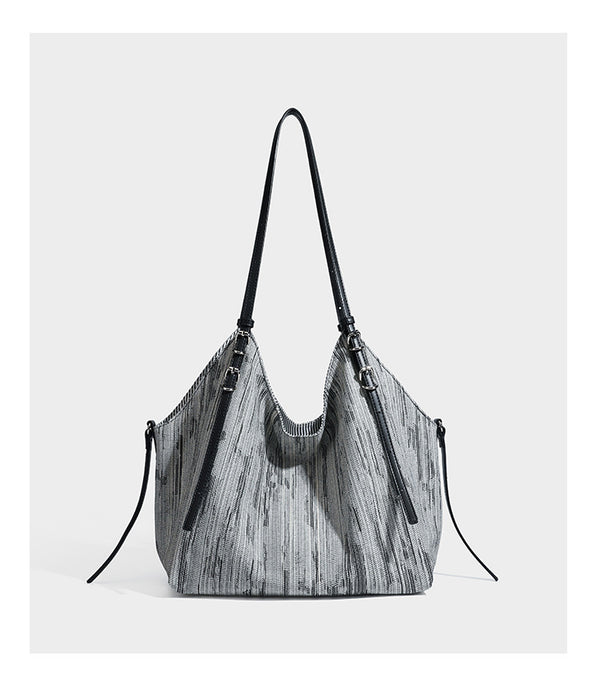 Large slouchy woven-texture shoulder tote bag with slim leather-look straps, side cinch ties, and silver-tone hardware