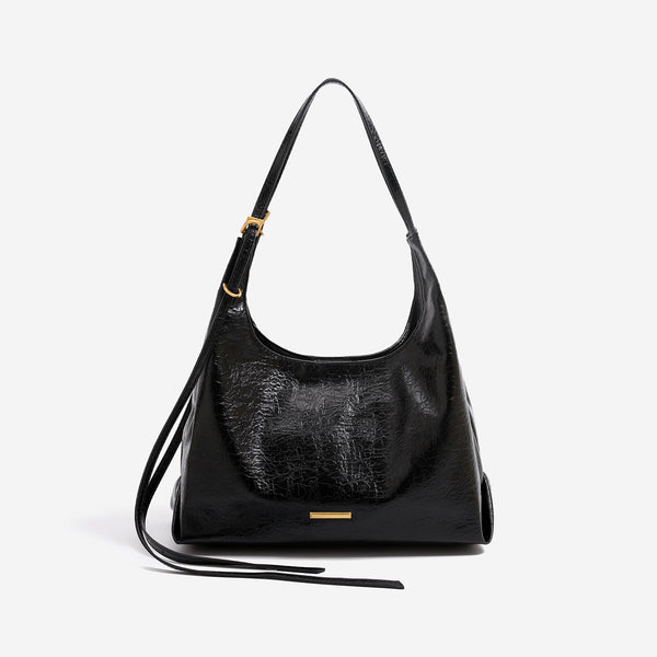 Slouchy hobo shoulder bag in crinkle high-gloss leather-look finish with gold-tone bar hardware and adjustable strap, detail