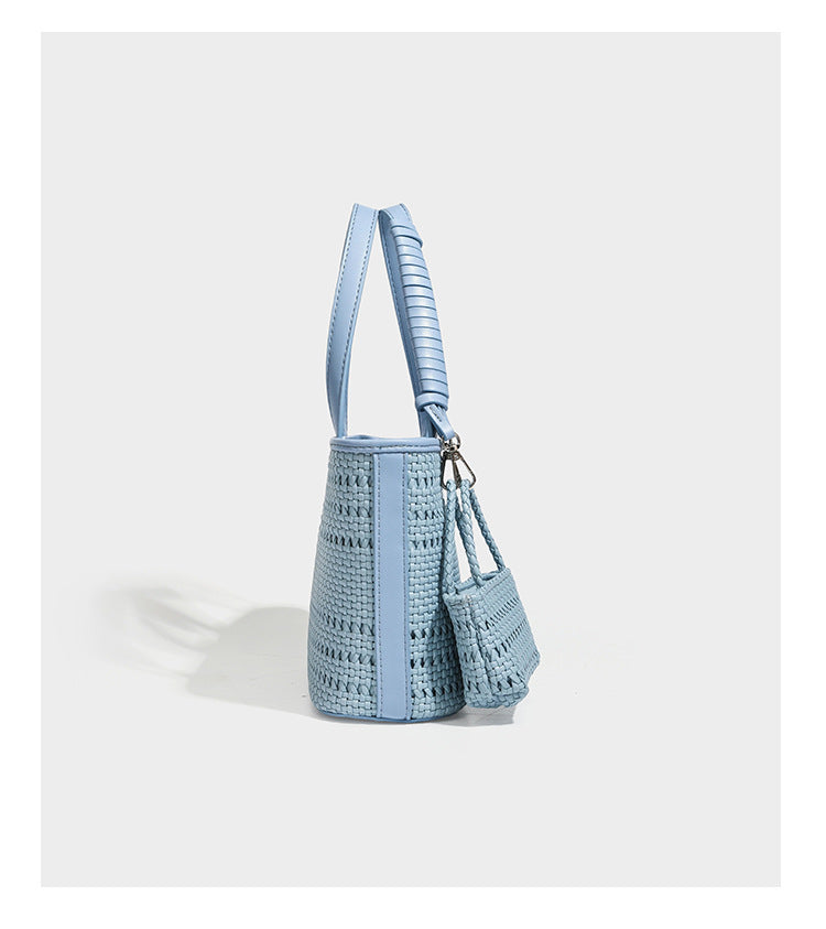 Structured open-weave tote bag with smooth leather-look trim, double top handles, detachable crossbody strap, and mini zip