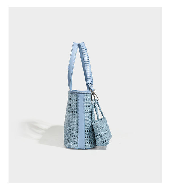 Structured open-weave tote bag with smooth leather-look trim, double top handles, detachable crossbody strap, and mini zip