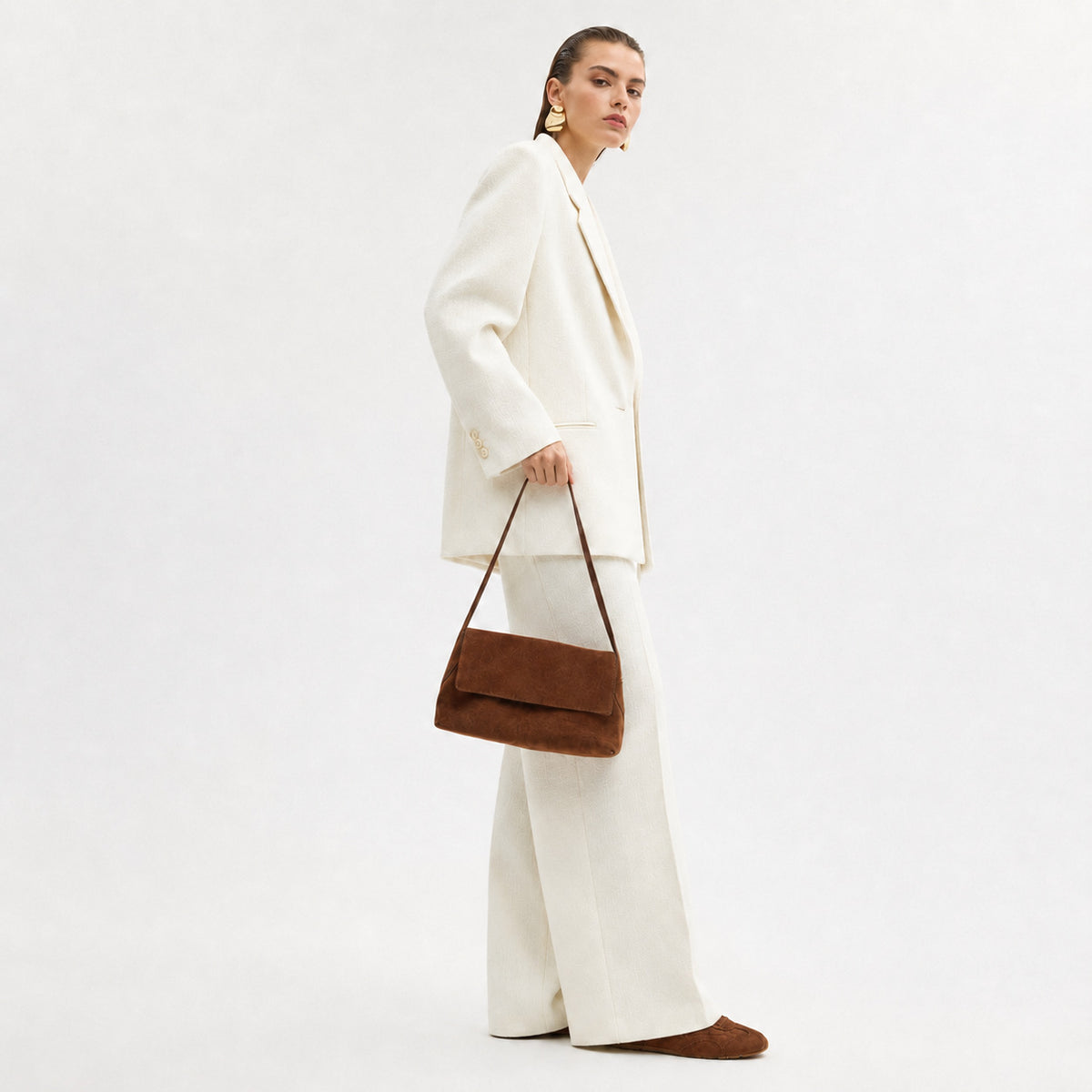 Rectangular matte suede-finish flap shoulder bag with slim dark strap and gold-tone turn-lock hardware, detail view 2