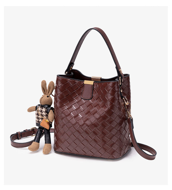 Brown woven-emboss leather-look bucket bag with short top handle, detachable crossbody strap, gold-tone hardware, and rabbit