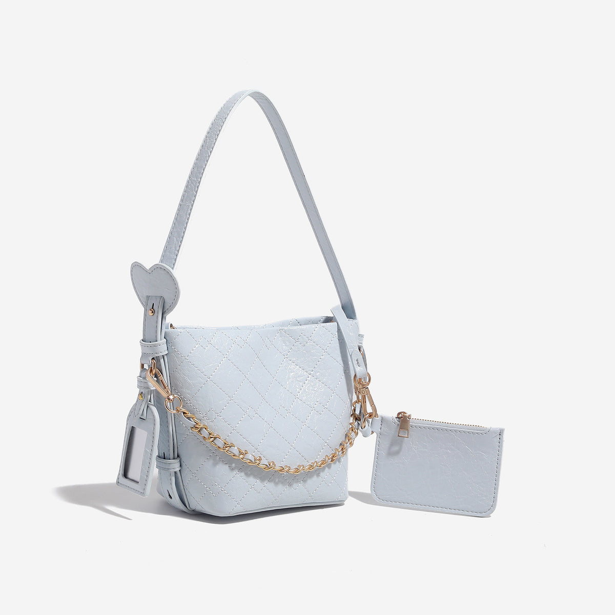 Small diamond-quilted bucket bag with gold-tone chain accent, heart strap detail, hanging tag, and matching zip coin pouch