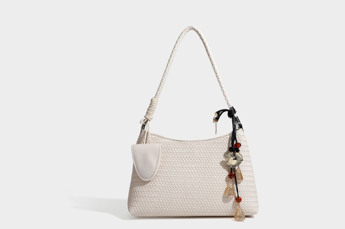 Woven-texture hobo shoulder bag in brown with braided top handle, adjustable crossbody strap, front flap pocket, and, detail