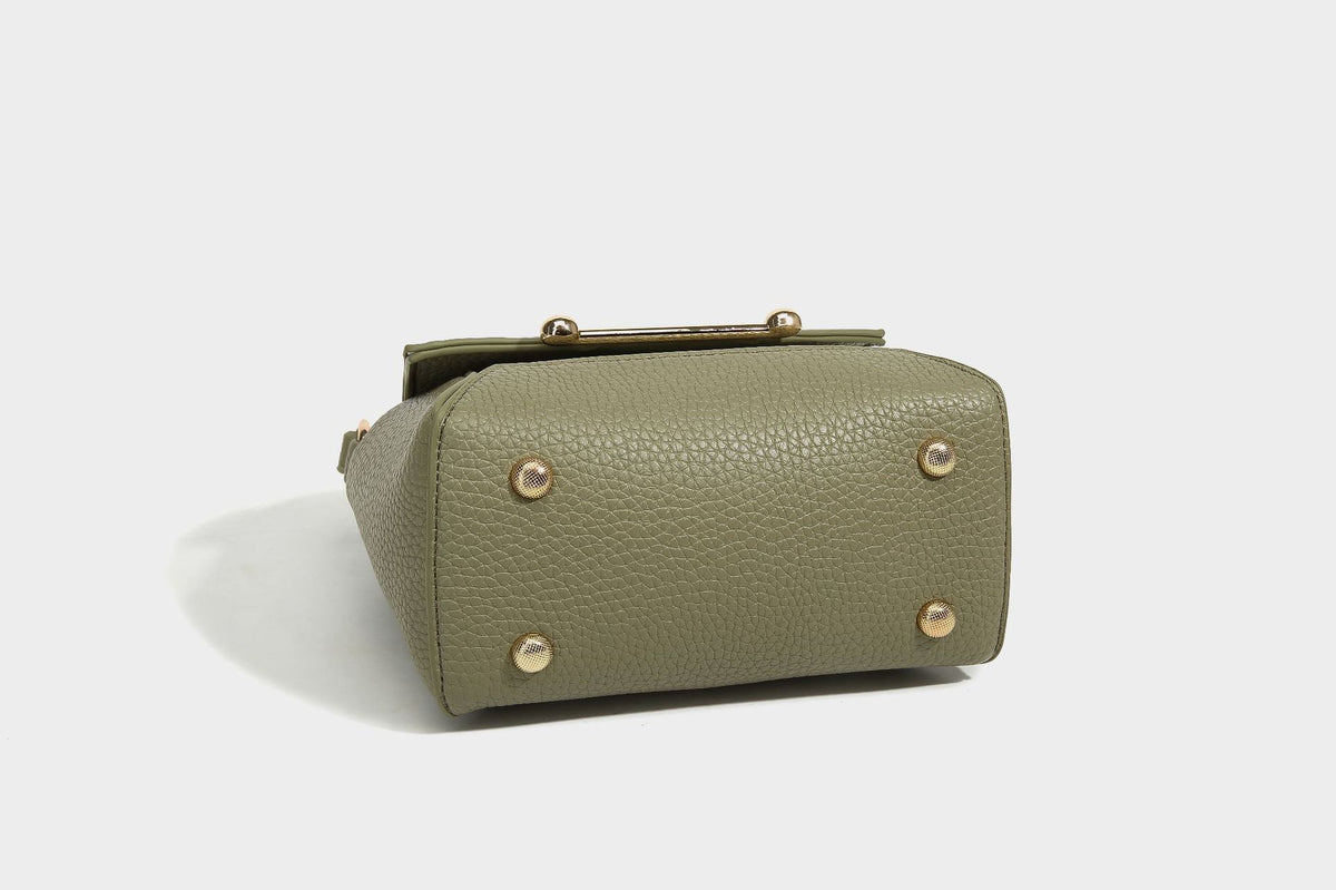 Small structured pebbled flap mini satchel with gold-tone bar hardware, short top handle, and detachable crossbody strap