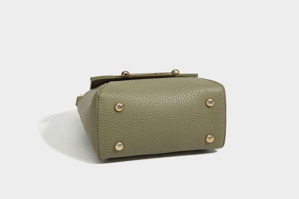 Small structured pebbled flap mini satchel with gold-tone bar hardware, short top handle, and detachable crossbody strap