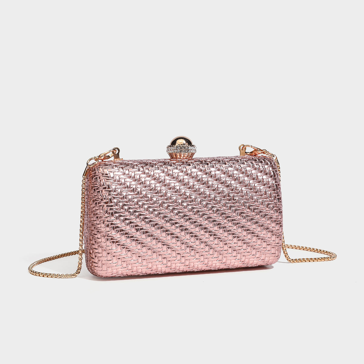 Small structured metallic woven-texture box clutch bag with jeweled kiss-lock dome clasp and slim gold chain strap, detail
