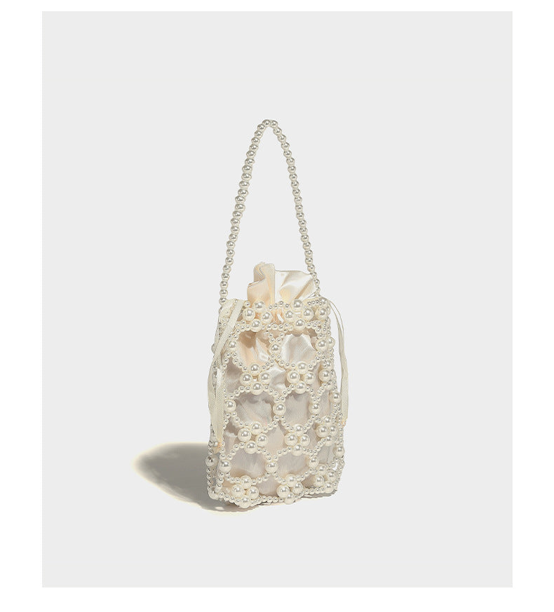 Small pearl-beaded lattice drawstring bucket bag with beaded shoulder strap and ribbon closure, detail view 10