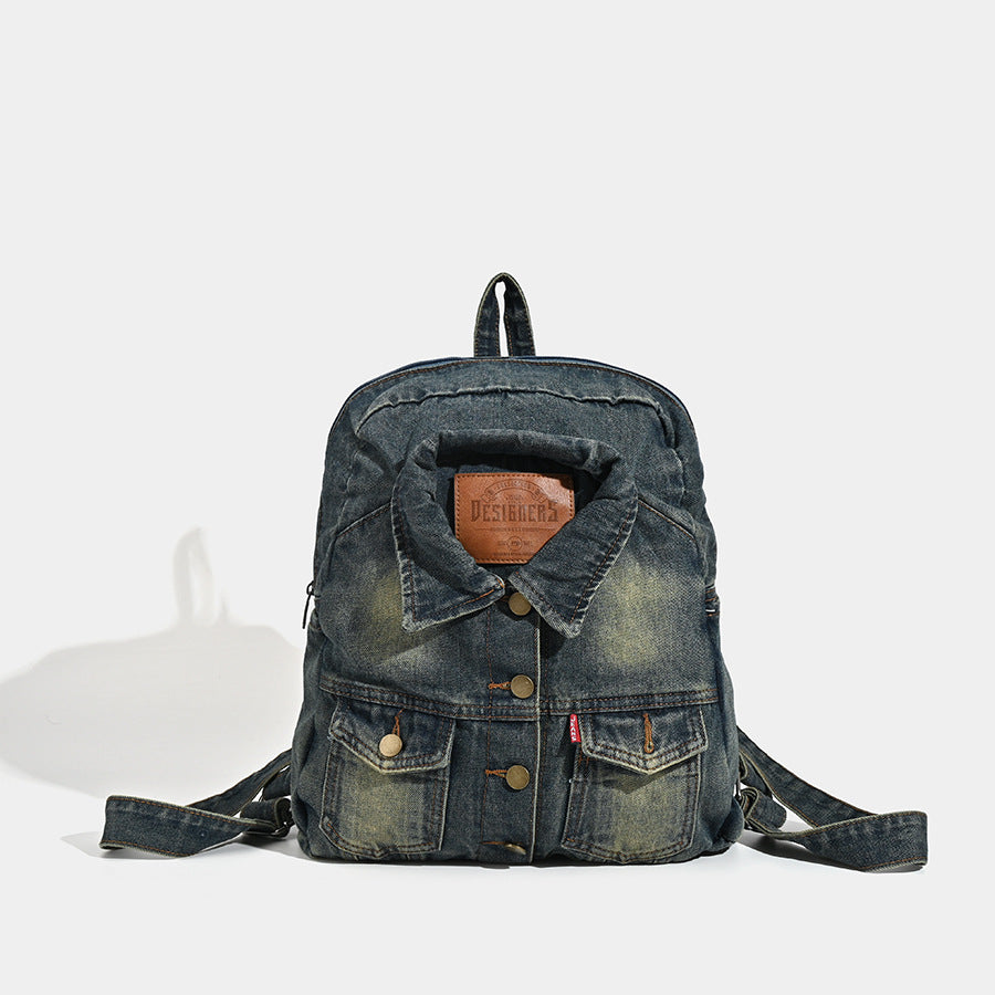 Vintage wash dark indigo denim backpack with jacket collar detail, snap buttons, patch pockets, and leather-look label
