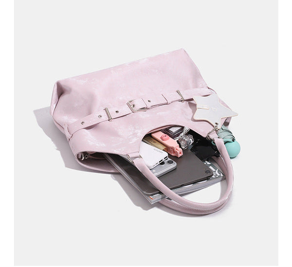 Large soft hobo shoulder bag with glossy textured finish, decorative belt buckle, star charm, and silver-tone hardware