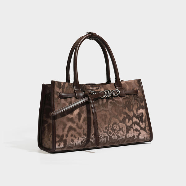 Structured leopard-print tote bag with glossy satin-like finish, dual rounded top handles, silver buckle-and-ring front
