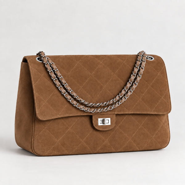 Quilted diamond-stitch flap shoulder bag with double silver chain strap and turn-lock closure in suede-look finish, detail
