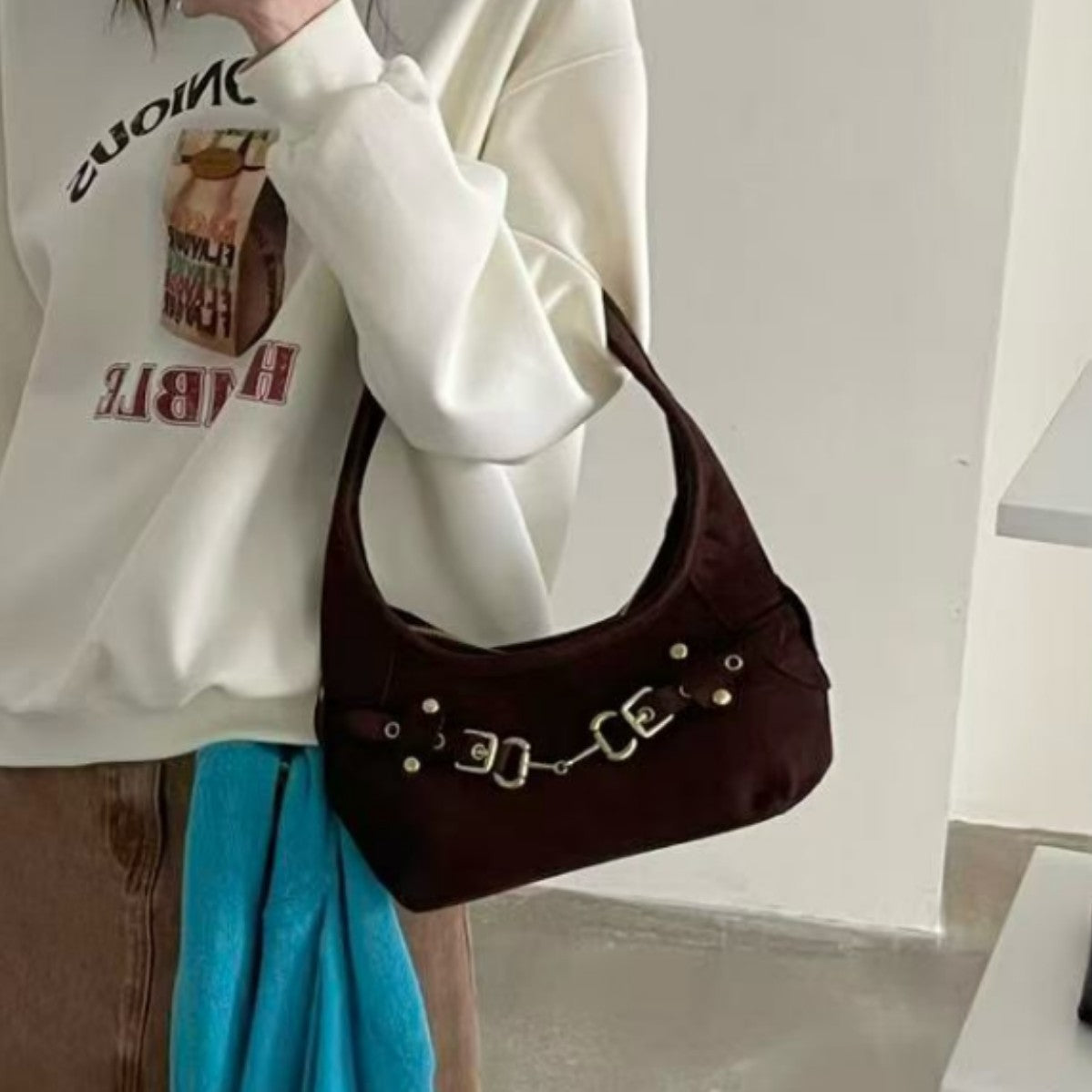 Matte suede-finish half-moon shoulder bag with gold horsebit bar hardware and dome studs, detail view 3