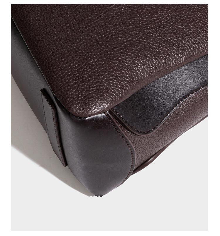 Structured pebbled leather-look shoulder bag with flap top, gold-tone emblem hardware, dual top handles, and detachable
