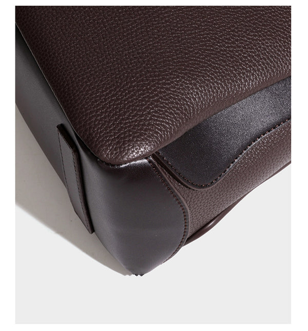 Structured pebbled leather-look shoulder bag with flap top, gold-tone emblem hardware, dual top handles, and detachable