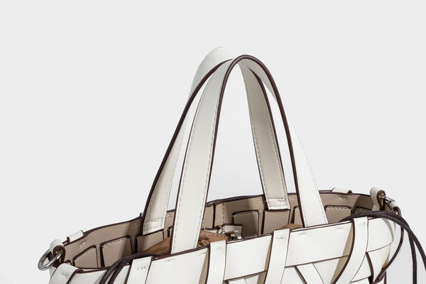Structured woven basket tote handbag with contrasting dark trim, double top handles, detachable shoulder strap, and