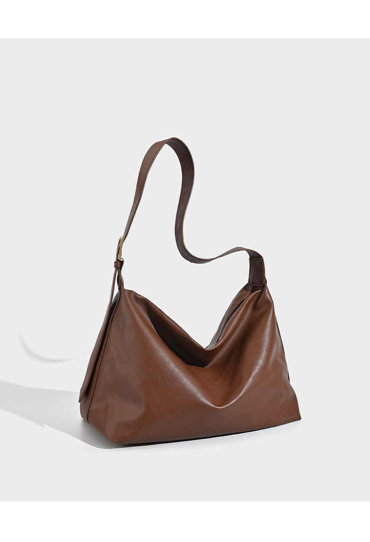 Large slouchy hobo shoulder bag in smooth black leather-look finish with gold-tone buckle hardware and adjustable strap