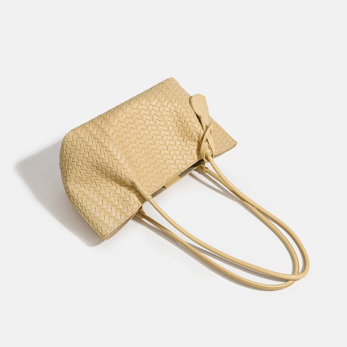 Woven leather-look tote bag in yellow with long shoulder straps, heart-shaped hanging charm, and removable inner zip pouch