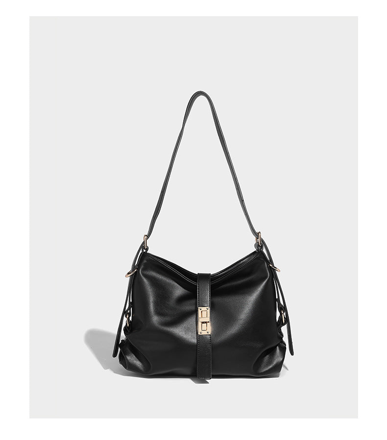 Soft slouchy hobo shoulder bag with smooth leather-look finish, gold-tone buckle and tab hardware, and long adjustable strap
