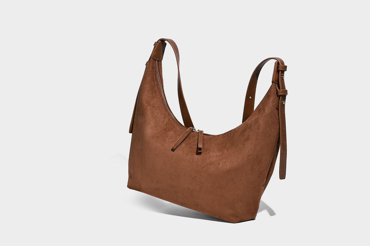 Slouchy crescent hobo shoulder bag in dark chocolate matte suede-look finish with adjustable strap and twin-pull top zip