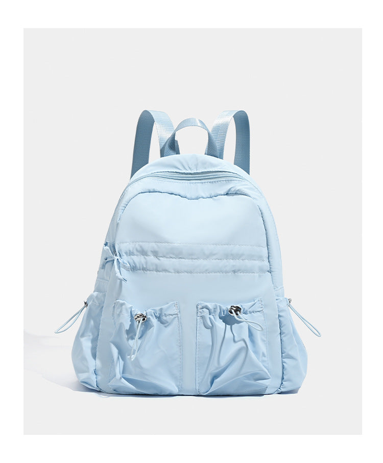 Puffy matte nylon mini backpack with drawcord gathered front pockets and silver-tone hardware, detail view 13