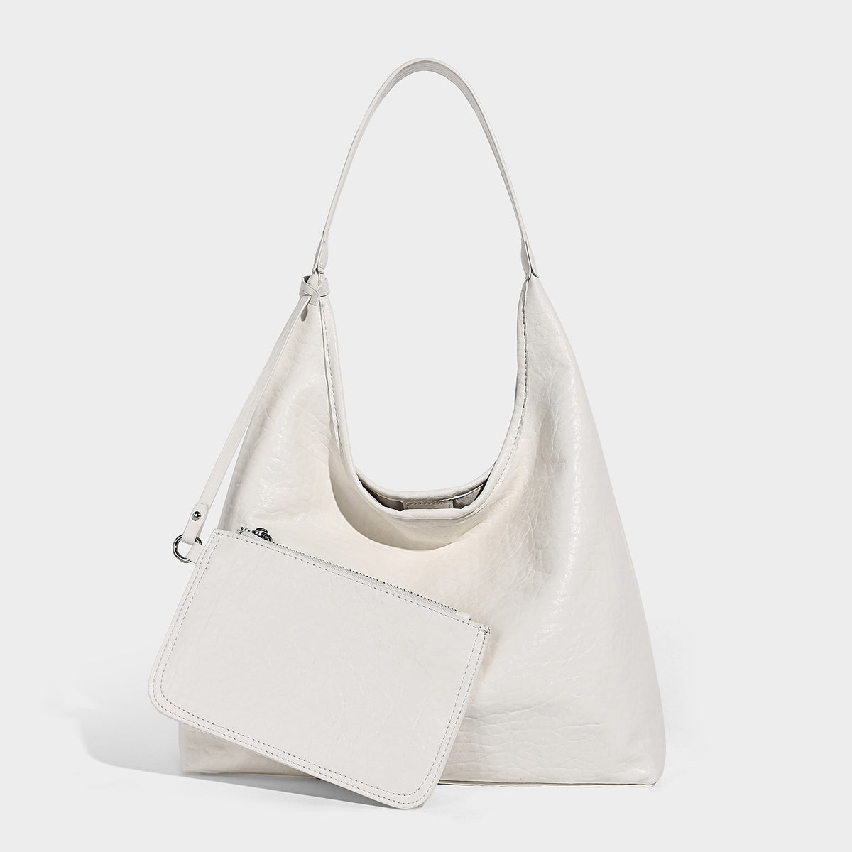 Slouchy hobo shoulder bag in pale yellow glossy pebbled leather-look finish with single shoulder strap and detachable front