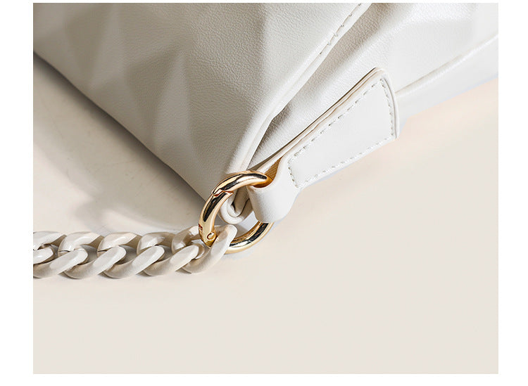 Cream white rectangular flap shoulder bag with geometric faceted surface and chunky tone-on-tone chain strap with gold-tone