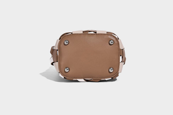 Small woven lattice bucket bag in tan and cream leather-look strips with drawstring top and detachable crossbody strap