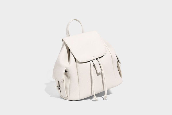 Compact pebbled leather-look flap drawstring backpack handbag with side pockets, top handle, and silver-tone hardware, detail