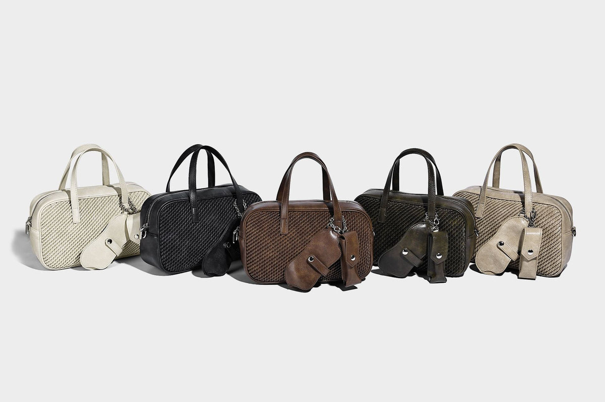 Structured woven-texture front top-handle handbag with zip closure, dual handles, detachable shoulder strap, and matching