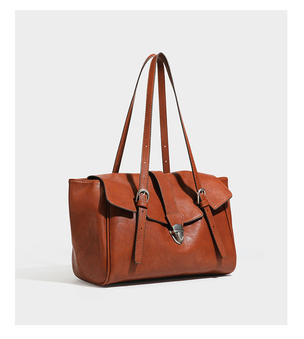 Large structured vintage-style tote bag with flap-front turn-lock closure, twin buckle straps, and double shoulder handles