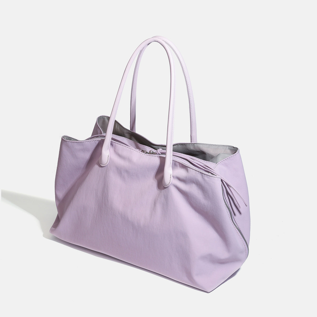 Large soft nylon tote bag with long double handles and zippered top in lavender, detail view 3