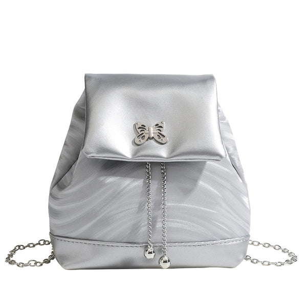 Compact ripple-embossed leather-look backpack handbag with silver butterfly clasp and chain straps, detail view 5