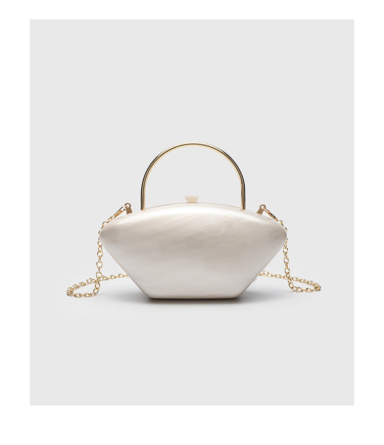 Shell-shaped pearlescent top-handle clutch bag with arched gold-tone metal handle and gold chain strap, detail view 12