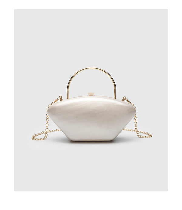 Shell-shaped pearlescent top-handle clutch bag with arched gold-tone metal handle and gold chain strap, detail view 12